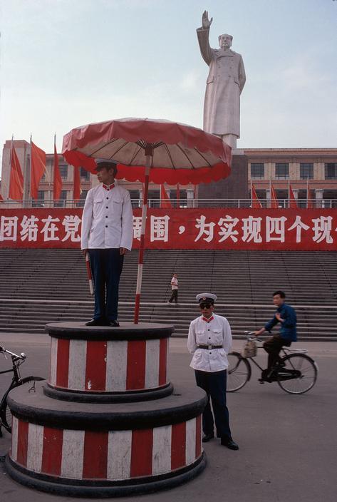 Un agent de la circulation travaille devant une statue du président Mao à Chengdu (1980).
