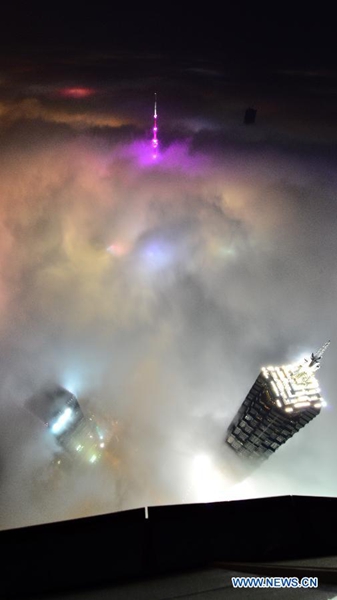 Des images prises depuis le 121e étage du Tour de Shanghai, mercredi 1er avril, où l’on aperçoit le Centre mondial des Finances (à gauche), la Tour Jin Mao (à droite), la Tour TV de la Perle orientale (au-dessus) dans une forte brume. [Photo/Xinhua]