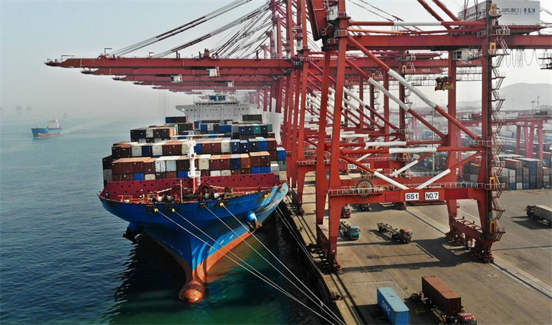 Photo aérienne prise par un drone montrant un cargo accostant au port de Qingdao, dans la province chinoise du Shandong (est), le 11 février 2024. Le port de Qingdao est occupé à traiter les marchandises destinées à l'exportation pendant les vacances de la fête du Printemps. (Photo : Li Ziheng)