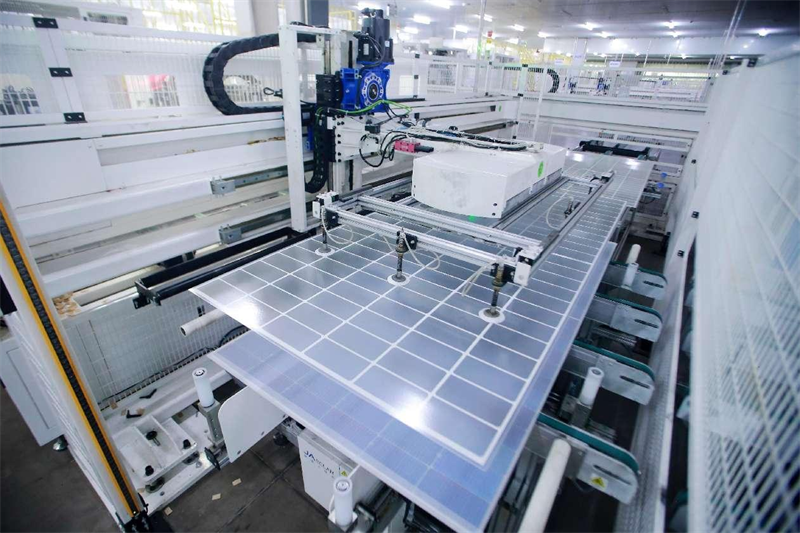 Dans une entreprise de production de produits d'énergies nouvelles de la ville de Yangzhou, dans la province du Jiangsu (est de la Chine), des robots industriels transportent des composants d'équipement photovoltaïque sur la chaîne de production. (Meng Delong / Pic.people.com.cn)