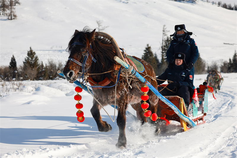 Xinjiang: la police d'Altay livre des produits de la fête du Printemps en traîneau à cheval