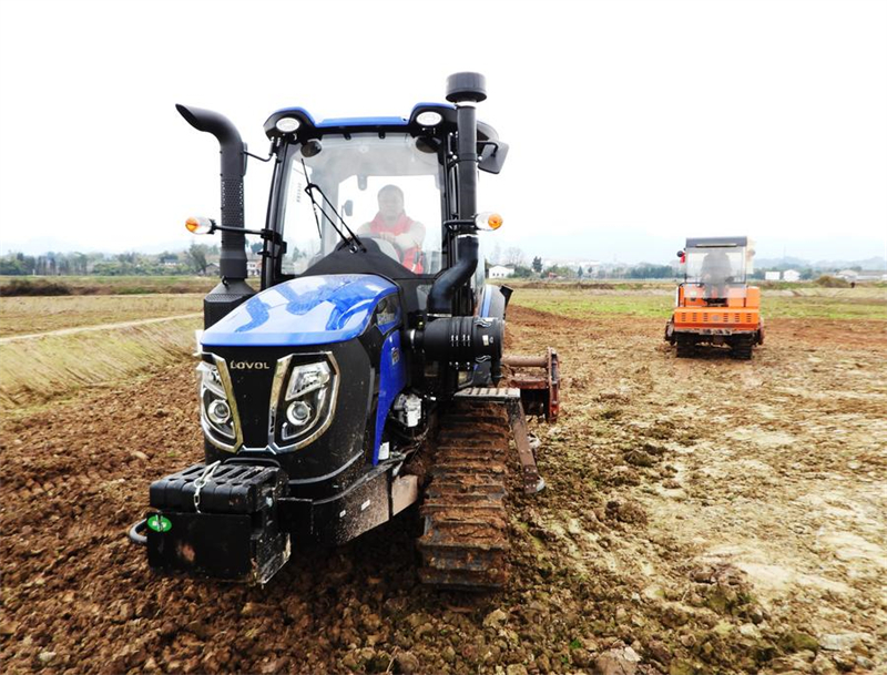 Des agriculteurs labourent à l'aide de machines en préparation des semailles de maïs dans la ville de Dazhou de la province chinoise du Sichuan (sud-ouest), le 21 février 2025. (Photo : Deng Liangkui)